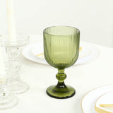 Green ribbed stemmed goblet with elegant table setting and gold accents