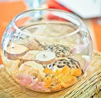Orange tropical table setting with tiki torch centerpiece