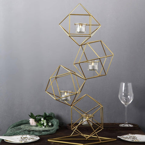 Gold geometric candle holders on a table