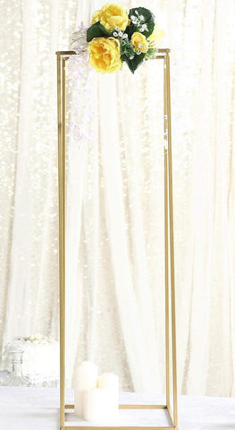 Tall gold flower stand with yellow floral arrangement