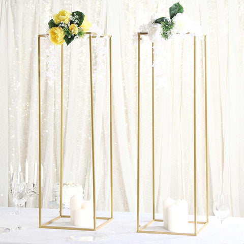 Gold display pedestals with floral arrangements