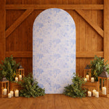 Decorative backdrop with floral patterns and greenery accents in a rustic setting.
