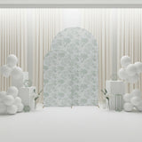 Decorative backdrop with floral design and white balloons in a staged scene.