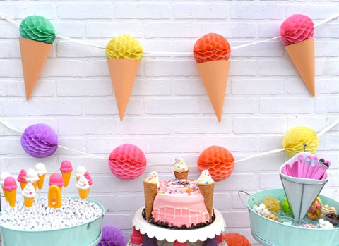 Ice cream party backdrop with balloon-letter sign and dessert table