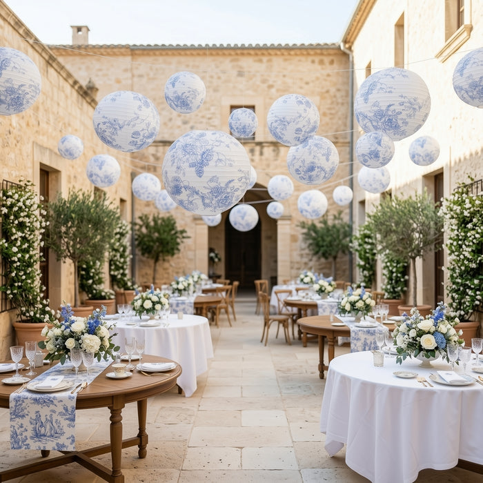 Elegant outdoor dining setup with floral decorations and hanging lanterns.