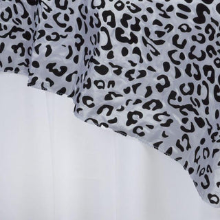 Transform Your Event Decor with the Black/White Taffeta Leopard Print Table Overlay