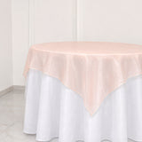 Round table with white skirt and blush pink sheer overlay tablecloth