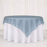 Blue sheer overlay round tablecloth on a white banquet table
