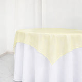 Yellow tablecloth with a soft, elegant drape on a white table.