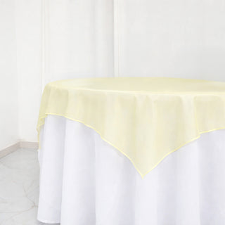 Yellow tablecloth with a soft, elegant drape on a white table.