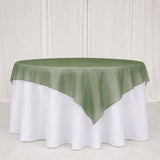 Green satin table overlay on white round banquet tablecloth
