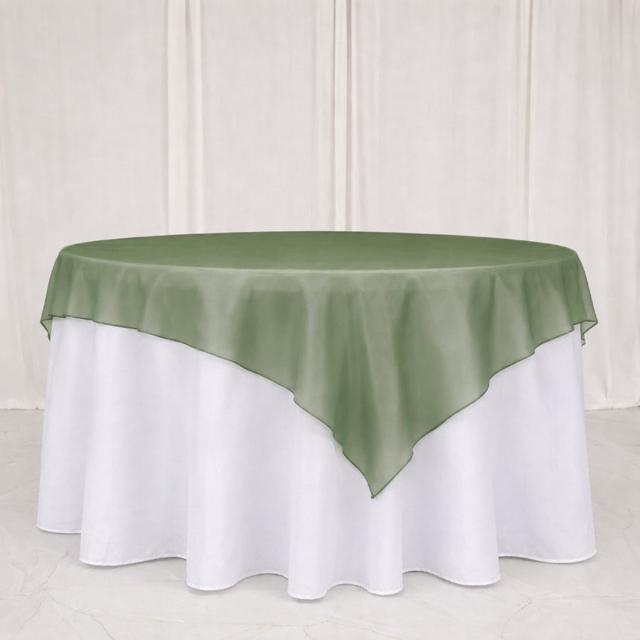Green satin table overlay on white round banquet tablecloth
