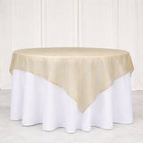 Gold tablecloth on a round table with white skirt