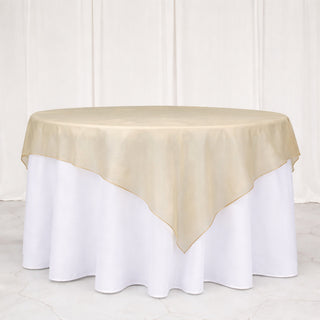 Gold tablecloth on a round table with white skirt