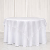 White round tablecloth with layered overlay on a table in a bright studio setting