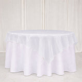 White round tablecloth with layered ruffle overlay on a table