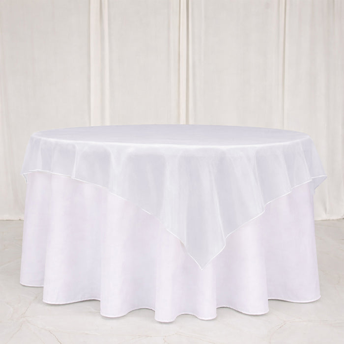 White round tablecloth with layered ruffle overlay on a table