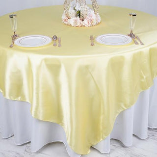 Dazzle Your Guests with a Yellow Satin Table Overlay