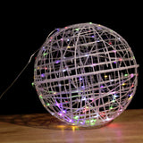 Decorative LED light globe with colorful lights on a dark background.