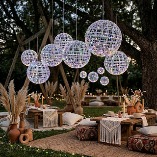 Outdoor boho-style event decor with hanging lights and rustic seating.