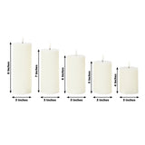 Set of five white pillar candles in various heights, each 3 inches in diameter.