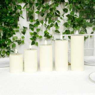 Set of five cream pillar candles on a table with greenery backdrop.