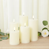 Set of six ivory pillar candles with flickering flames and ribbed texture.