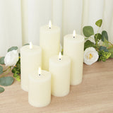 Set of six ivory pillar candles with flickering flames and textured surfaces.
