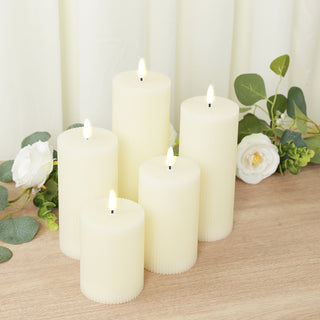 Set of six ivory pillar candles with flickering flames and textured surfaces.