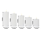Set of five white candles in various heights on a plain background.