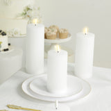 White ribbed flameless pillar candles on a decorated table