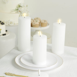 White ribbed flameless pillar candles on a decorated table