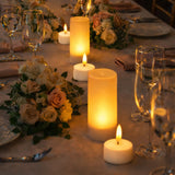Elegant dinner table set with candles and floral arrangements.