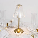 Gold LED table lamp with clear fluted shade on elegant dining table setting