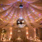 Disco ball with colorful lights at elegant wedding reception venue