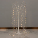 LED weeping willow tree decor at elegant event reception aisle