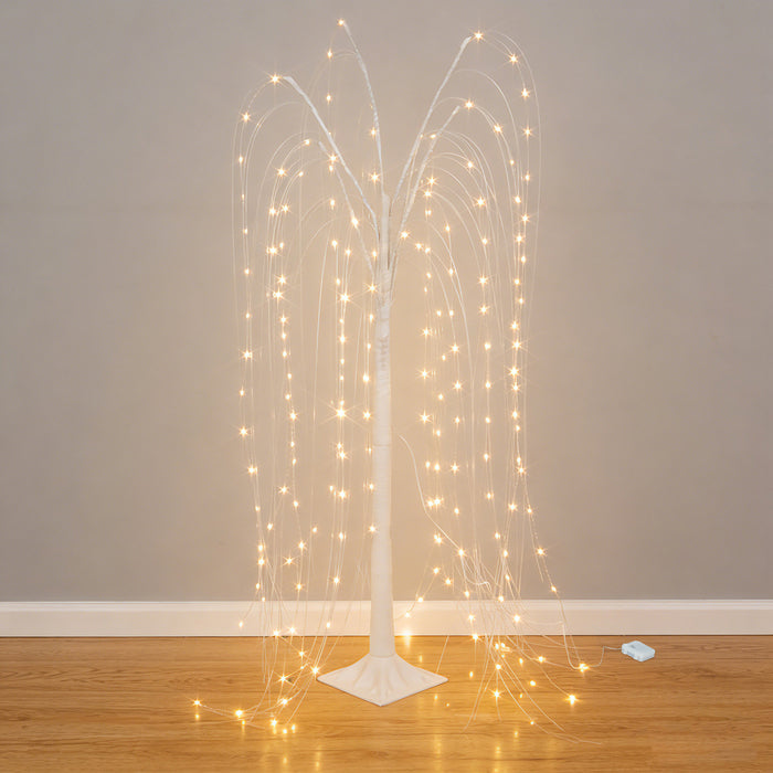 Illuminated decorative tree with cascading lights on a plain backdrop.