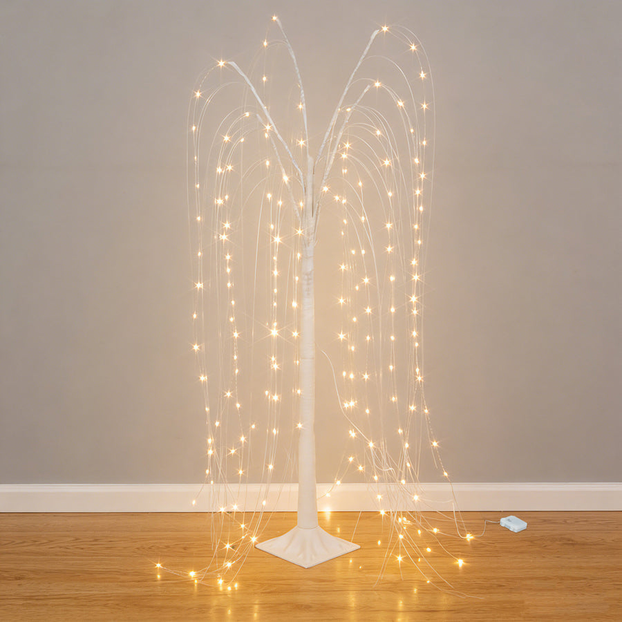 Illuminated decorative tree with cascading lights on a plain backdrop.