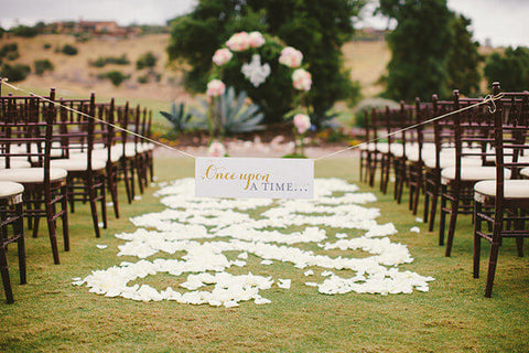 Outdoor ceremony aisle with floral arch