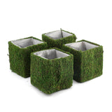 Artificial flower arrangements in moss-covered planters. #whtbkgd
