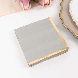 <strong>Elegant Gray Paper Beverage Napkins With Gold Foil Edge</strong>