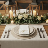 Elegant table setting with floral decor, candles, and dinnerware.