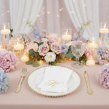 Elegant table setting with flowers and candles for a special occasion.