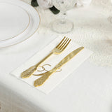 Gold fork and knife on a decorative napkin, elegantly set on a table.