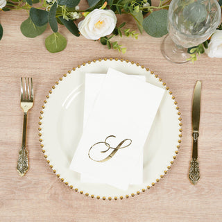 Elegant gold-embellished plate with napkin and fork on a wooden table setting.