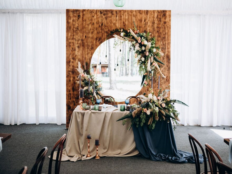 Winter rustic sweetheart table with birch logs and candles