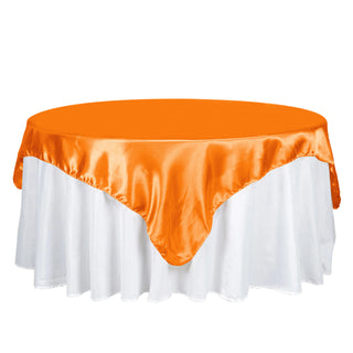 Add a Pop of Elegance with the 72x72 Orange Seamless Satin Square Tablecloth Overlay