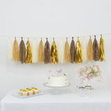 Decorative tassel garland in gold, cream, and brown for party decor.