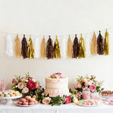 Elegant party decorations with tassels, cake, and dessert table.