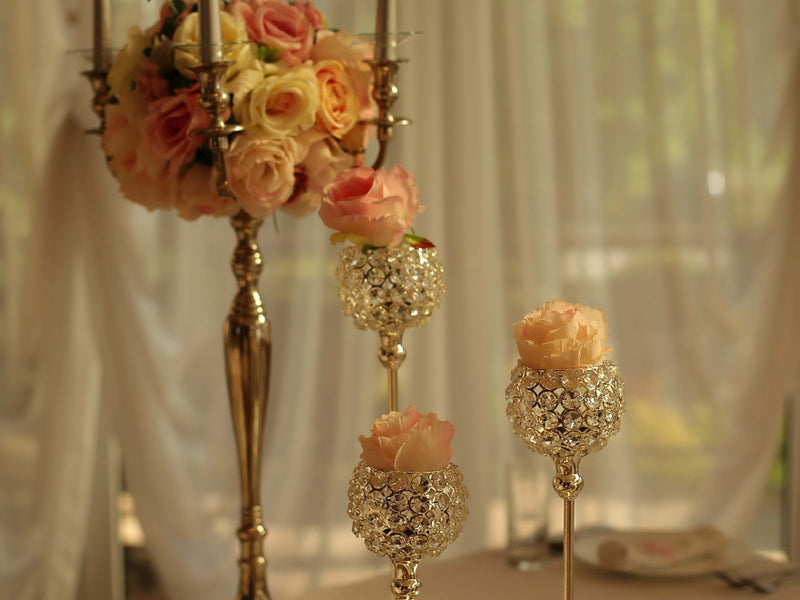 Pink roses in jeweled gold candleholders
